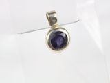 a close up of a pendant with a blue stone on it
