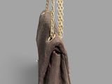 a close up of a purse with a chain hanging from it ' s side