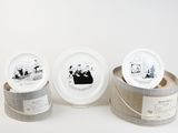 three white plates with pictures of people on them