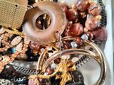 a tray full of assorted jewelry on a table