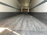 a truck that is inside of a building with a lot of wood flooring