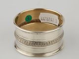 a silver ring with a green stone in the center
