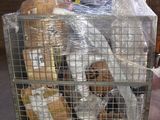 a metal cage with a bunch of stuffed animals inside of it
