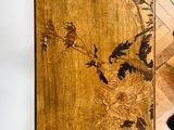 a wooden table with a vase on top of it on a wooden floor