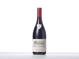 a bottle of red wine sitting on top of a table