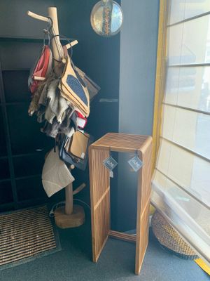 une pile de vêtements suspendus à un portant dans un coin de la pièce