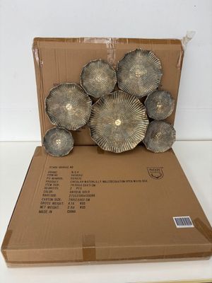 a cardboard box that has a bunch of metal flowers in it