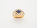 a gold ring with a blue sapphire and diamonds