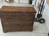 a wooden chest sitting on the floor in a room