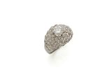a close up of a diamond ring on a white surface