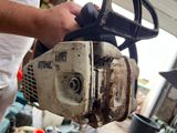 a man that is using a chainsaw to cut a piece of wood
