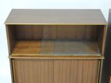 an image of a wooden cabinet with a glass shelf on top of it