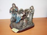 a figurine of a group of people sitting on a table