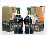 two bottles of brandy are sitting next to each other in front of a box