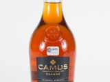 a close up of a bottle of whisky on a white surface