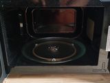 a microwave that is open on a wooden table