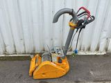 a small machine that is sitting on the side of the street
