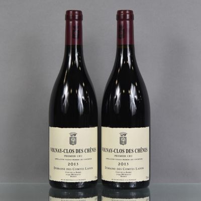 two bottles of wine sitting on top of a table next to each other
