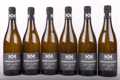 six bottles of wine are lined up in a row