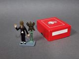 a small figurine of a man and a statue of an angel