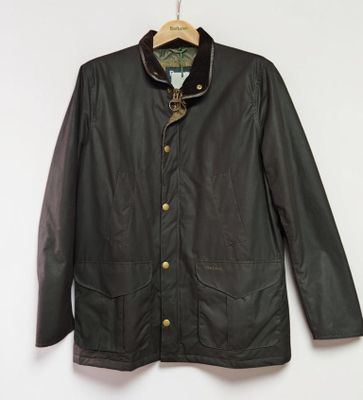 a black jacket hanging on a wall next to a wooden hanger