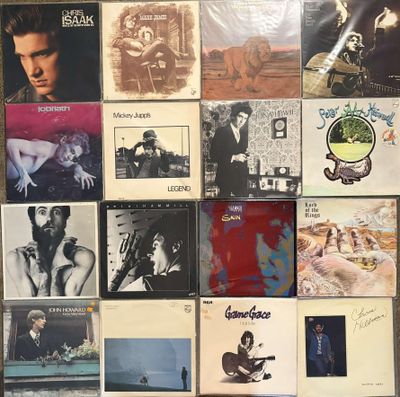 the wall is covered with many different albums and cds