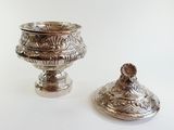 two silver vases sitting next to each other on a table