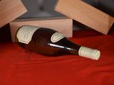 a bottle of wine sitting on a table next to two wooden blocks
