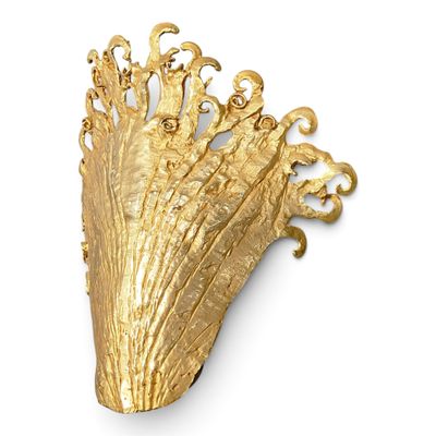 gold leaf wall sconce on a white wall with a white background