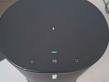 an image of a black speaker sitting on top of a white table
