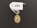 a gold coin with a small dog on it ' s side
