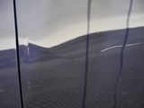 a reflection of a mountain in the mirror of a car