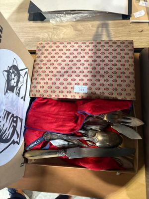 a box of silverware sitting on top of a table