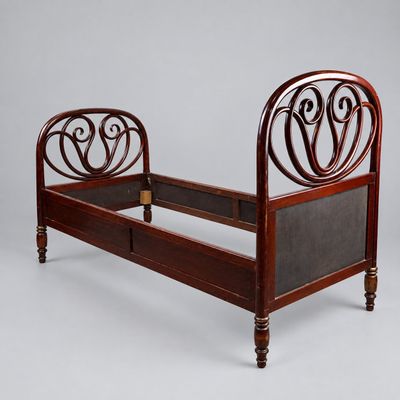 an image of a bed with a wooden frame and a metal headboard
