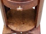 a small round table with a glass top and a wooden base