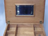 a small wooden box with a mirror in it