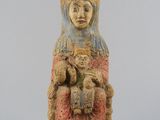 an old statue of a woman holding a baby in her arms