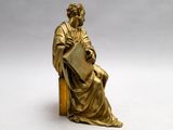 an image of a statue of a man sitting on a chair
