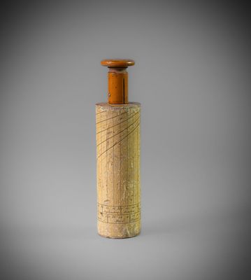 une petite bouteille en bois surmontée d'un bouchon en bois