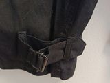 the back of a pair of black jeans with a buckle on it