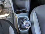 a close up of a car ' s gear box with a clock on it