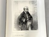 un livre ouvert sur lequel figure le dessin d'un homme en costume-cravate