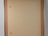 an empty picture frame hanging on the wall in a room