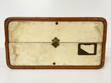 an old suitcase is sitting on a white surface with a brown handle