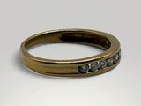 a close up of a gold ring with black diamonds on it