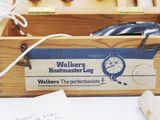 a wooden box with a watch inside of it on a table