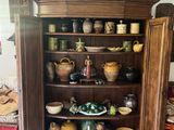 a wooden cabinet with a lot of dishes on top of it
