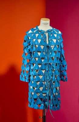 a mannequin on a stand with a blue jacket on it