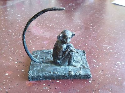 a statue of a monkey sitting on top of a table