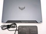 a laptop that is sitting on a table with a charger